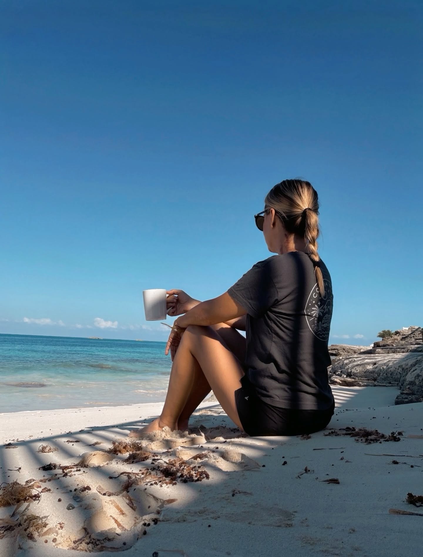 Jan Ruley on the beach with coffee