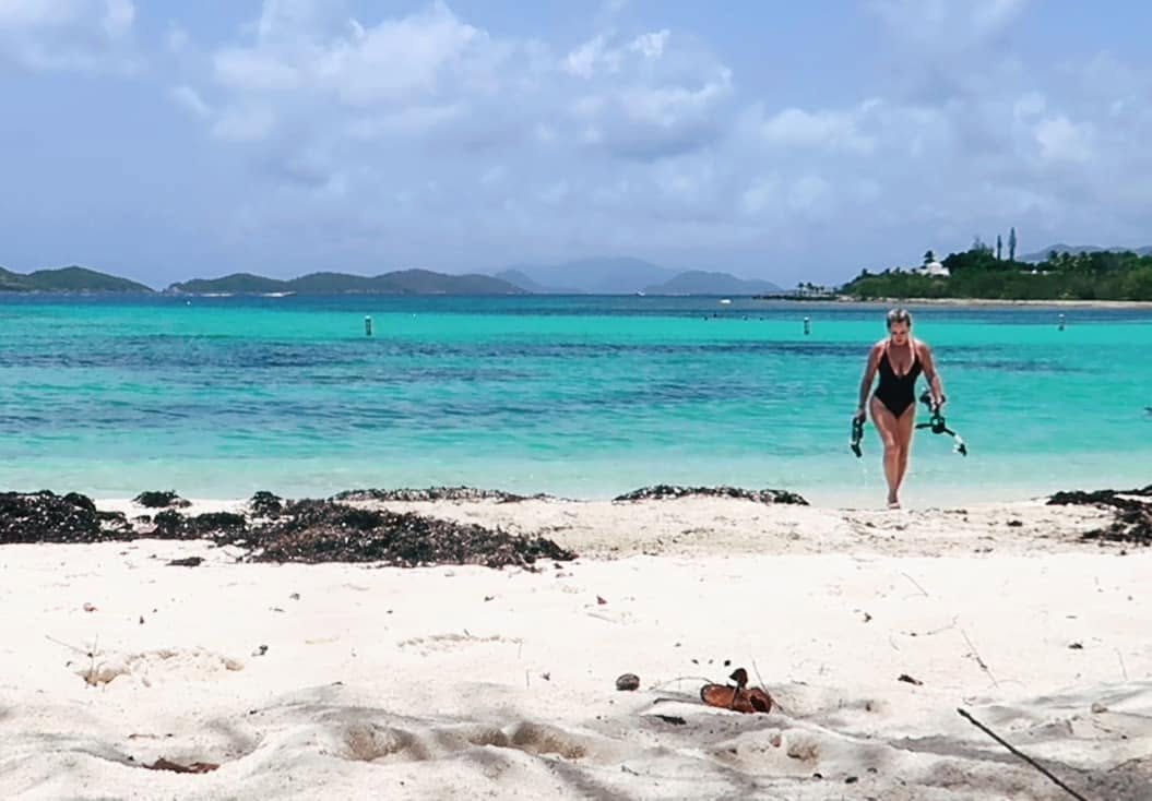 Jan walking out of the sea with fins